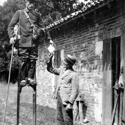 French Postman stilt walkers